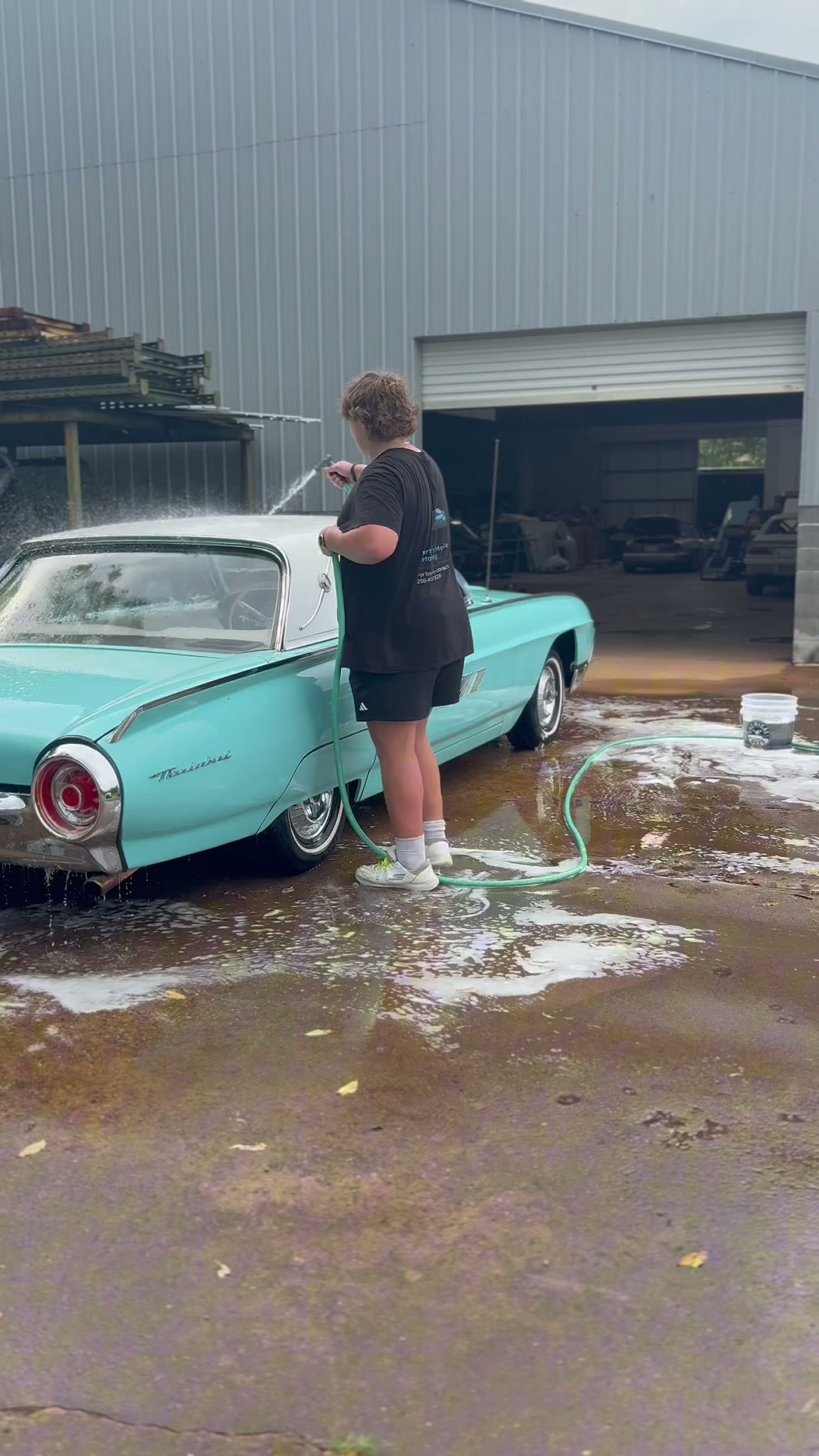 Classic teal 1963 Ford Thunderbird being hand washed by JP's Mobile Detailing