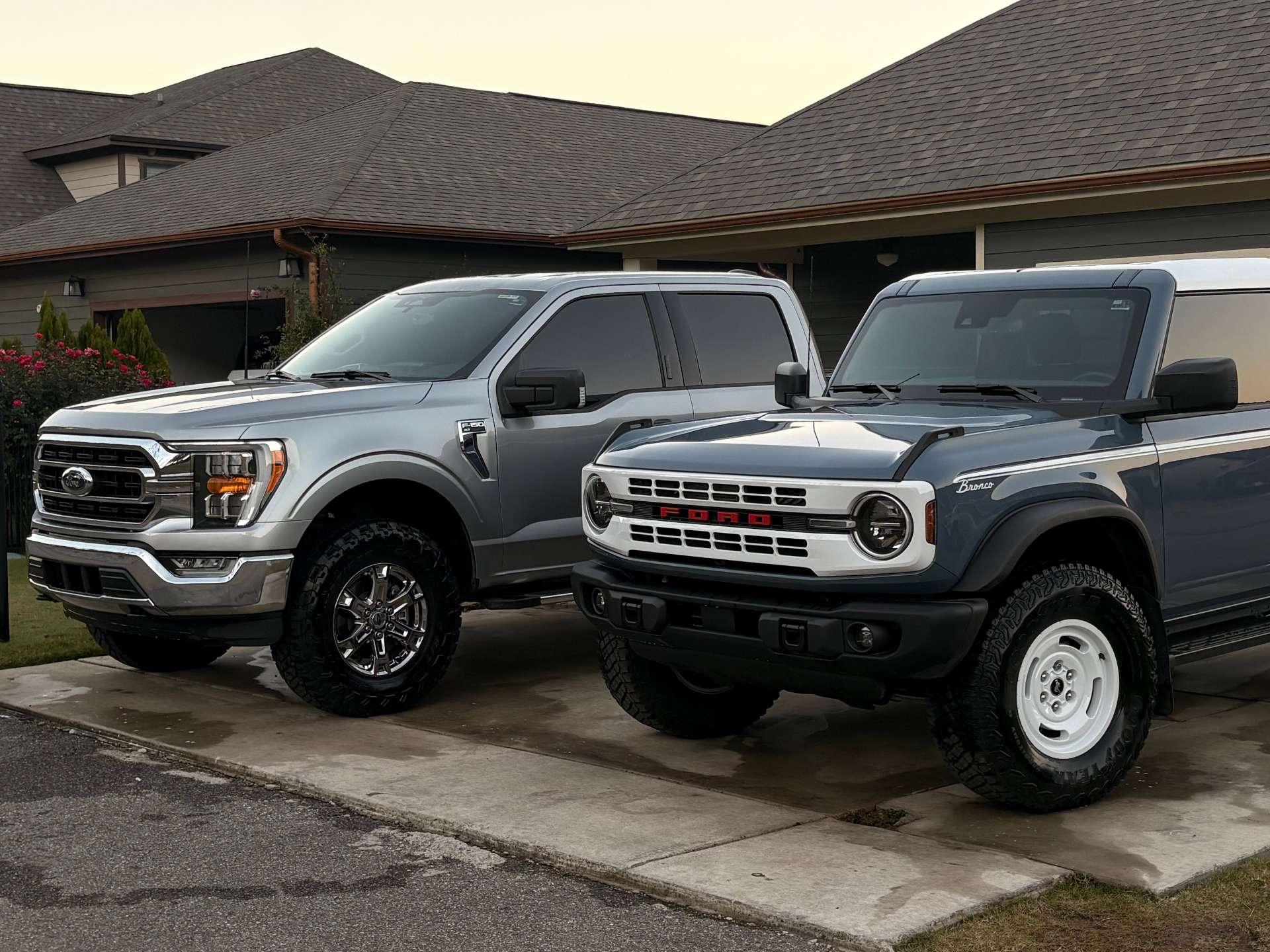 Freshly detailed Ford F-150 and Bronco side by side at golden hour